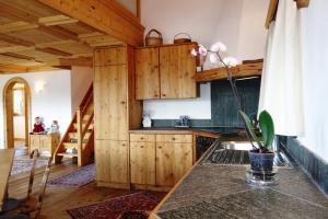 a kitchen with wooden cabinets and a table at Chesa il Rifugio 1 in St. Moritz