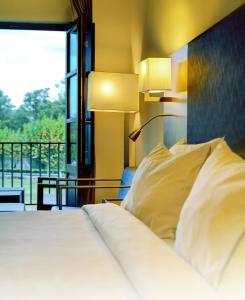 Łóżko lub łóżka w pokoju w obiekcie Oca Vila de Allariz Hotel Balneario