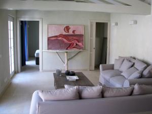 a living room with a couch and a table at Maison RR in Saint-Tropez