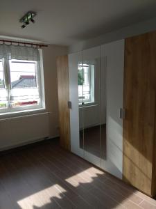 a room with a glass door and two windows at apartmány pod lesem in Bohutín