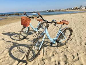 a bike with a basket sitting on the beach at Hotel Tritone Rimini in Rimini