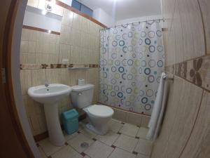 a bathroom with a sink and a toilet and a shower at Hospedaje el Telar in Nazca