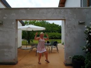 a young girl is standing under an umbrella at Aganis in Casarsa della Delizia