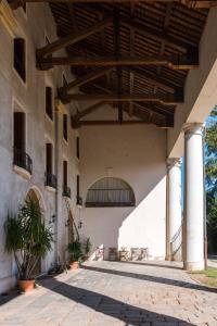 a large building with awnings and a patio at Villa Peschiera in Gazzo