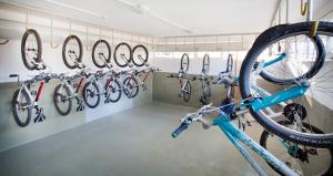 a room with a bunch of bikes hanging on a wall at Aminess Vival Maestral Hotel in Novigrad Istria