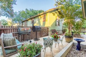 a tiny house with a grill in a yard at Agape Front Cottage in Fredericksburg