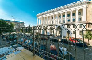 a fence with cars parked in a parking lot at VIP Apartment at Horodetskoho 4 in Kyiv