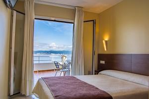 Postel nebo postele na pokoji v ubytování Hotel Restaurante Loureiro
