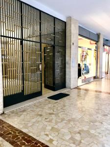 a lobby with black doors and a tile floor at Affittacamere Pratello 97 in Bologna