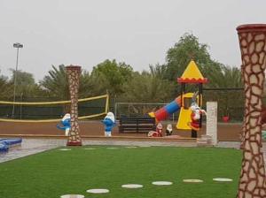 a park with a playground with a play equipment at Al Reef Rest House in Al Khārī
