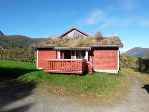 a small red house with a grass roof at Ridderkroa Tresfjord in Tresfjord