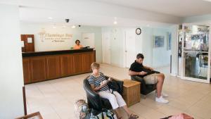 a couple of people sitting in chairs in a waiting room at Flamingo Bay Hotel & Marina in Freeport