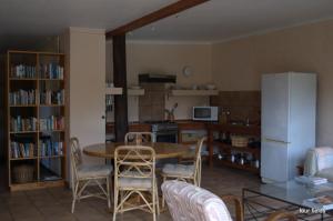 a kitchen with a table and chairs and a refrigerator at Four Fields Farm in The Crags