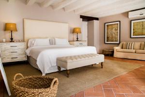 
a hotel room with a bed and a dresser at Hotel Casa Don Sancho By Mustique in Cartagena de Indias
