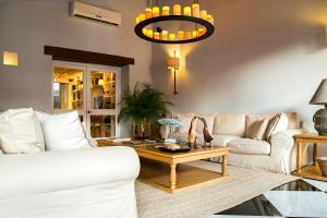 
a living room filled with furniture and a lamp at Hotel Casa Don Sancho By Mustique in Cartagena de Indias
