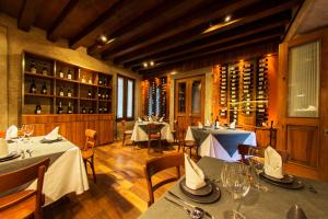 a restaurant with tables and chairs and wine bottles at Hotel Boutique Casa Madero in Morelia