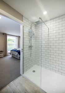 a bathroom with a shower with a glass door at Darlington Arms in Redhill