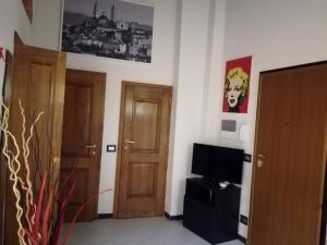 a living room with two doors and a television at Nonna Anna in Siena