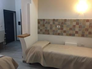 Ένα ή περισσότερα κρεβάτια σε δωμάτιο στο Affittacamere Gallurà