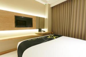 Tempat tidur dalam kamar di Yellow Star Gejayan Hotel