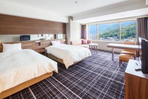 Postel nebo postele na pokoji v ubytování Kofu Kinenbi Hotel