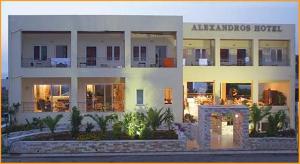 a large white building with a hotel at Alexandros Hotel in Sisi