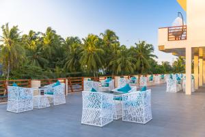 a row of tables and chairs on a patio at White Sand Dhigurah in Dhigurah