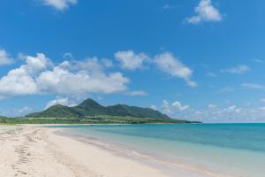 a view of a beach with mountains in the background at Nata Beach Villa in Ishigaki Island