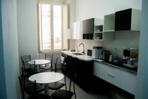 a kitchen with two tables and chairs and a counter at Civico 7 in Naples
