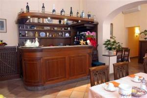 a bar in a restaurant with a table and chairs at Hotel Beatrice in Florence