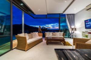 a living room with a view of the city at Kamala Seaview villa by Lofty in Kamala Beach
