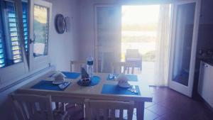 a dining room table with blue napkins on it at Villa Ancora B&B in San Vito lo Capo