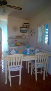 a white table and two chairs in a room at Villa Ancora B&B in San Vito lo Capo
