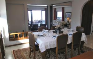 a dining room table with a white tablecloth and chairs at Villa Markos in Roitika