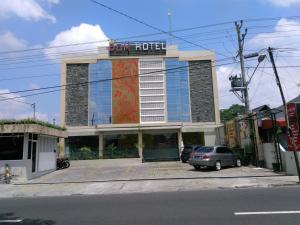 a building with a car parked in front of it at DOM Hotel Jogja in Yogyakarta