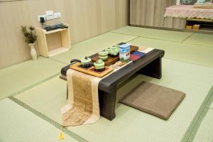 a room with a table with cups on it at Ji Shih Life Style Hotel in Tainan