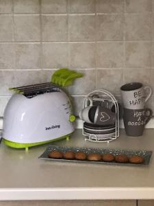 a kitchen counter with a toaster and some muffins at Como Palace in San Pellegrino Terme