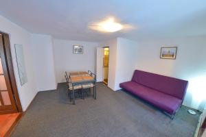 a living room with a purple couch and a table at Apartment Gabriel in Sibiu