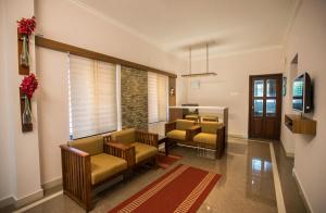 a waiting room with two chairs and a table at Anchorage Serviced Apartments in Cochin