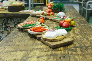 a wooden table with plates of food on it at Hotel Superski in Cavnic