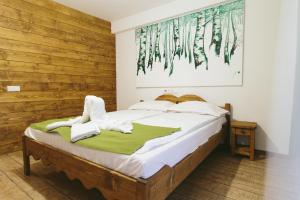 a bedroom with a bed with a wooden wall at Hotel Superski in Cavnic +37 photos