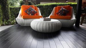 three chairs with orange cushions and a table at The Fong Krabi resort in Krabi