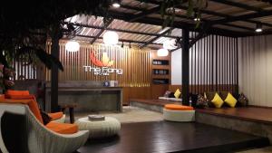 a lobby with chairs and tables and a sign on the wall at The Fong Krabi resort in Krabi town