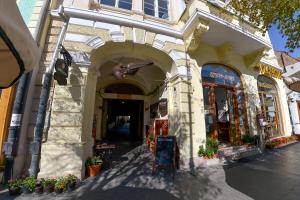 a building with an archway in front of a street at Apartment Gabriel in Sibiu