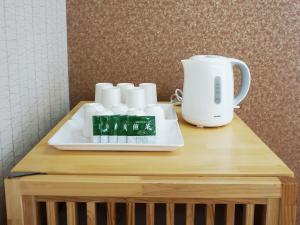 a table with a coffee maker and cups on it at Hotel Abest Naha Kokusai Street in Naha