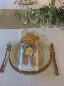 a plate of food on a table with wine glasses at Hostal Talabart in Les