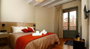 a bedroom with a bed with two towels on it at Kazas Luxury in Dimitsana