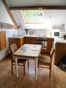 a kitchen with a table and chairs and a sink at Dolifor in Llanwrthwl