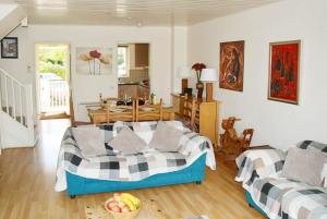 a bedroom with a bed and a living room at Swan Lake Lodge in Cirencester