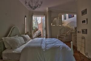 a bedroom with a bed in a room with a staircase at Dar El Hout in Hout Bay